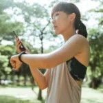 Aura Labs verified customer — Asian woman athlete checking fitness watch